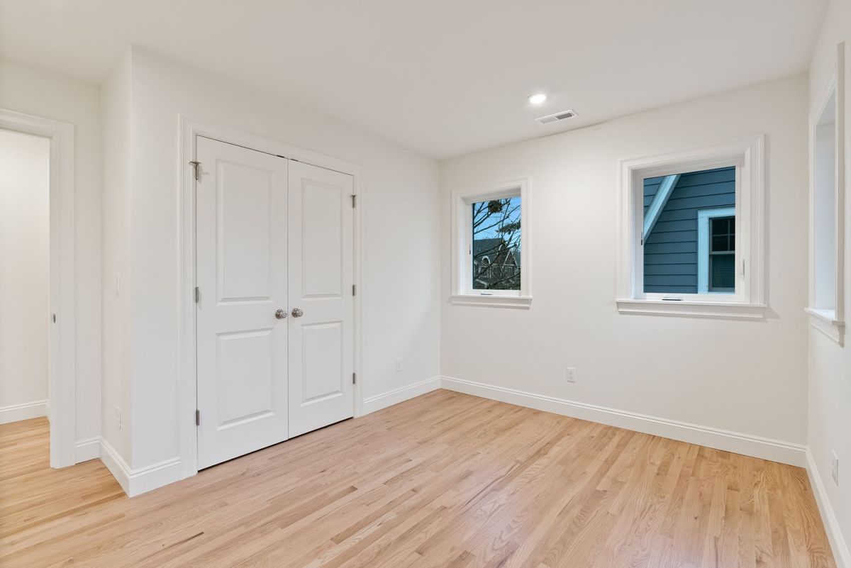 Second-floor bedroom with two windows and built-in closet