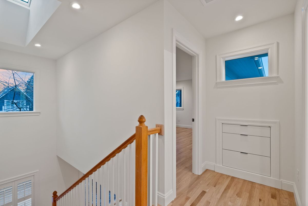 Stair up to the new second floor, oak treads matching the main level