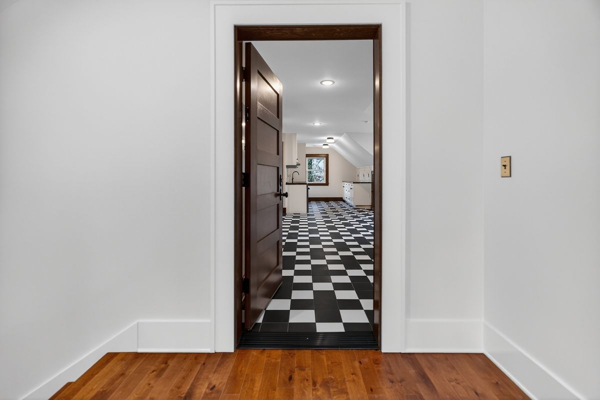 Stained wood door opening from the landing into the ADU