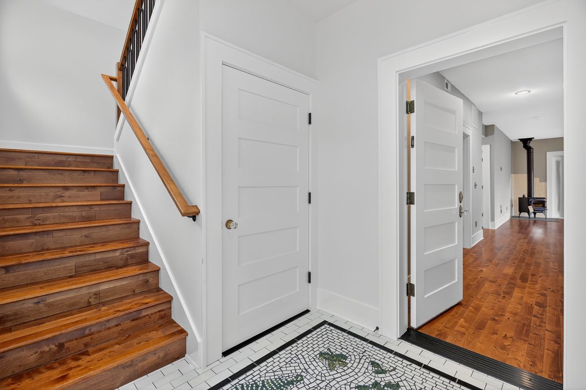 Entry hall with stair and mosaic tile floor in a new North Portland home