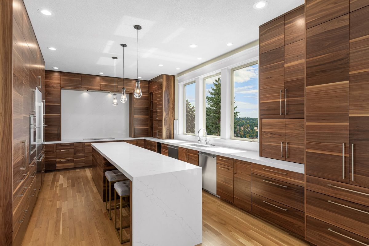 Kitchen toward the three new casement windows and the sink run