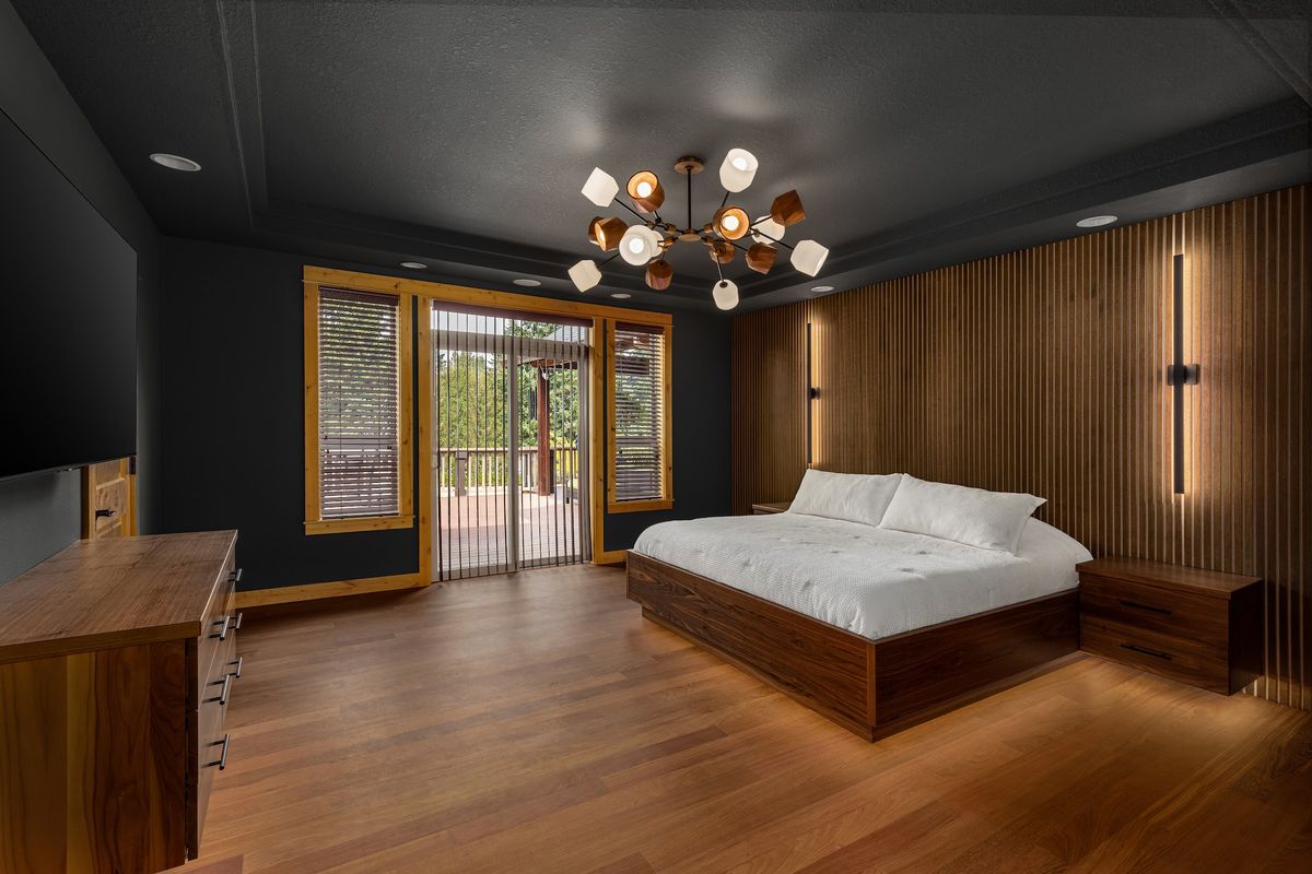 Primary bedroom: walnut slat wall, platform bed and sconces