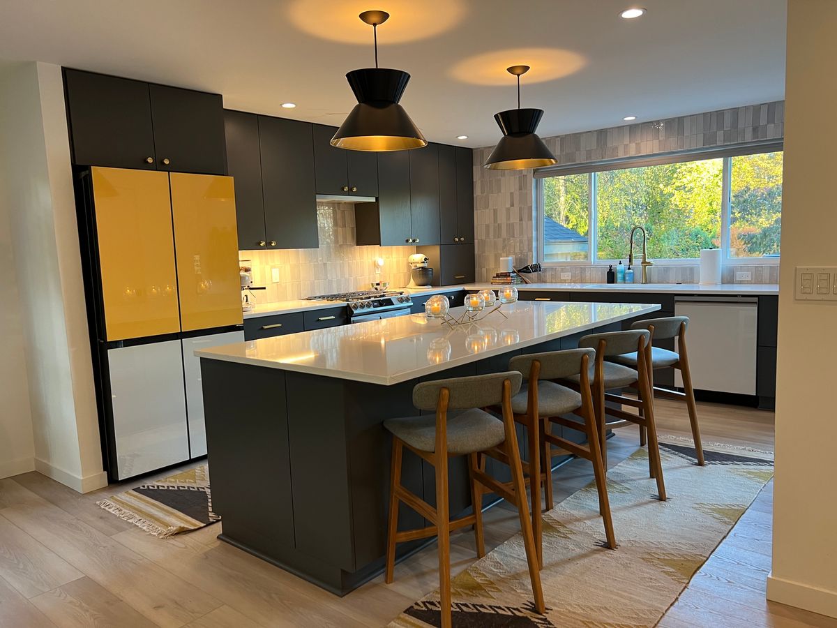 SW Portland whole-home remodel — kitchen with black cabinetry and yellow refrigerator
